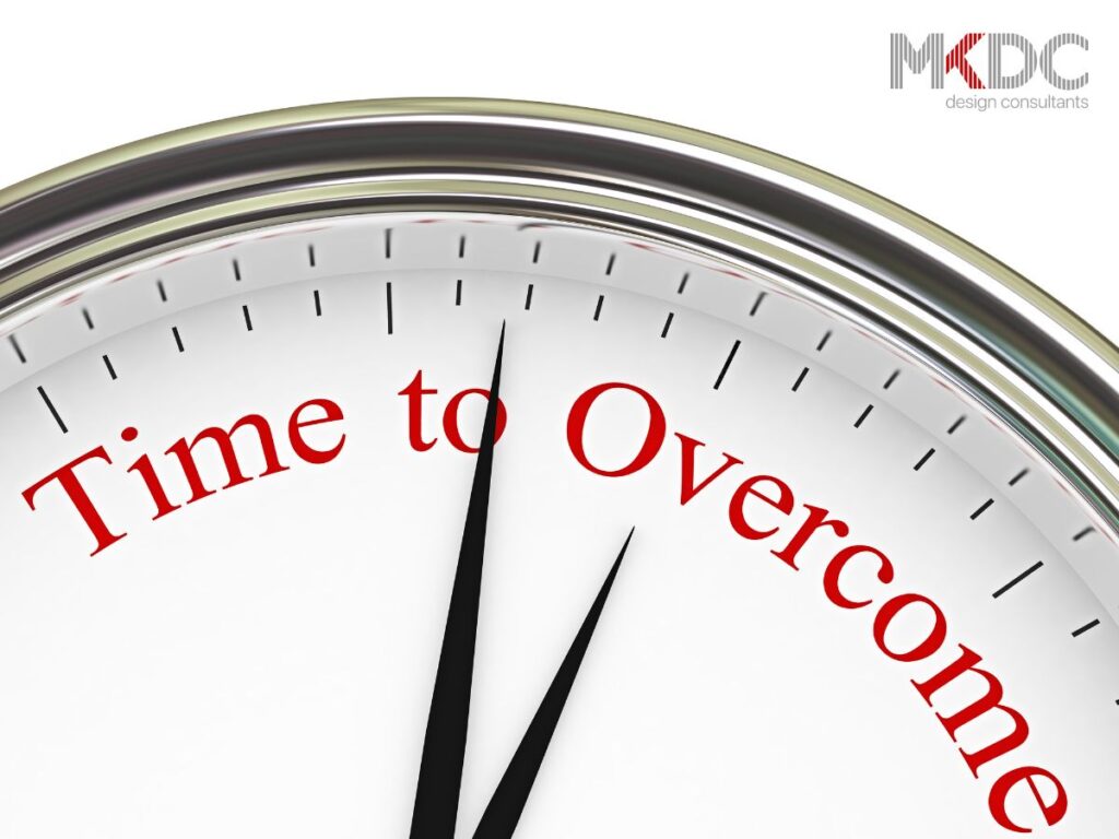 A close-up clock with "Time to Overcome" in red.