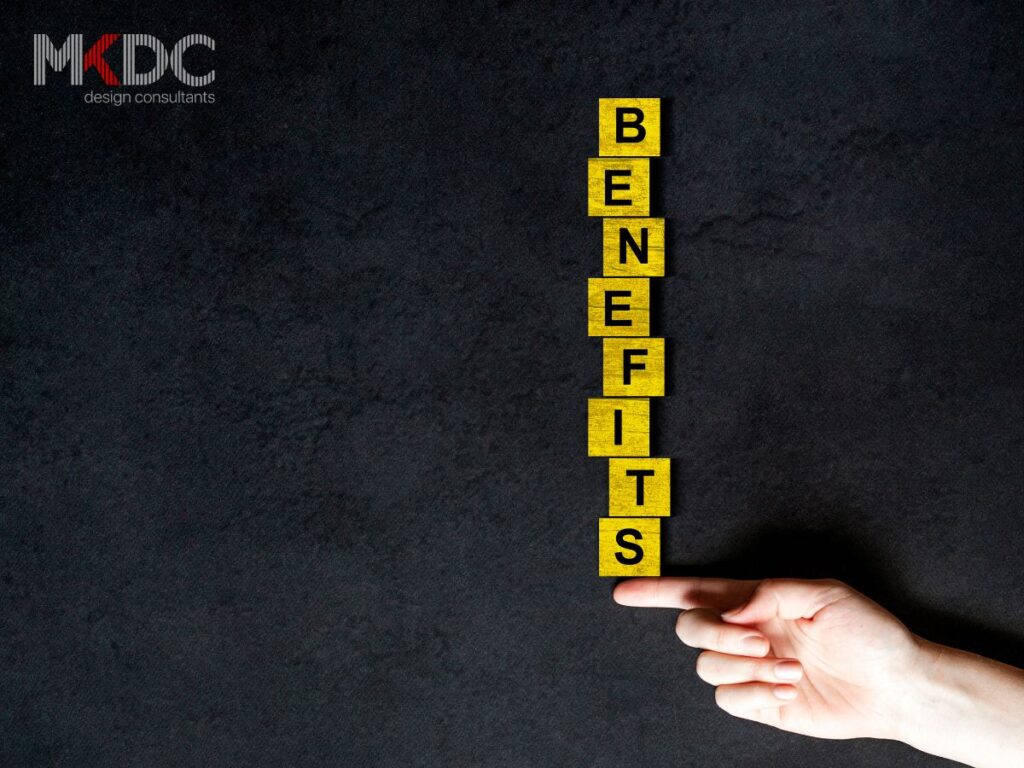 Yellow blocks spelling "BENEFITS" stacked vertically, balanced on a pointing finger.
