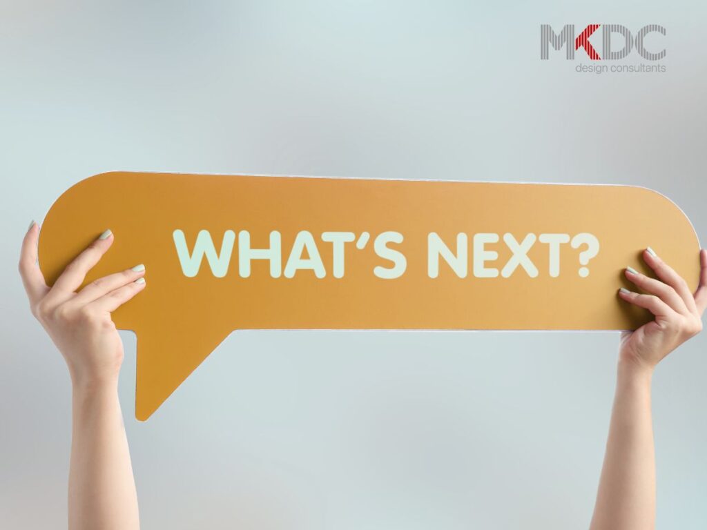 Two hands holding a large speech bubble with "WHAT'S NEXT?" written on it.
